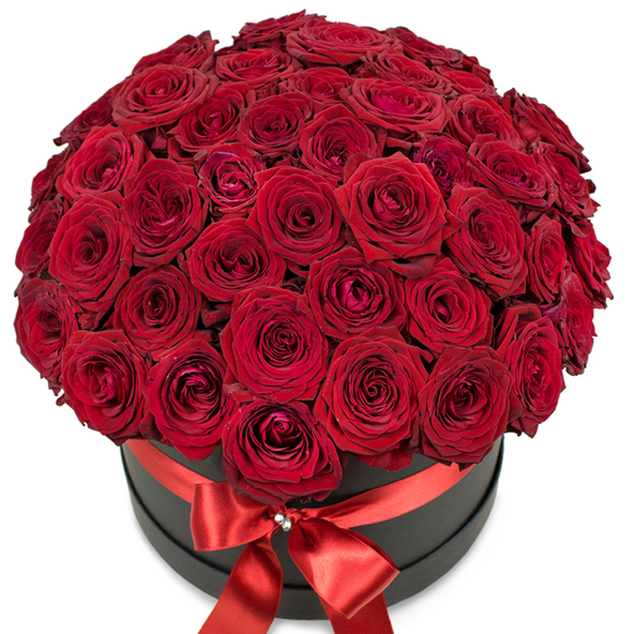 Presented in a round, jet-black matte hatbox, a sumptuous abundance of velvety red roses forms a luxurious dome, overflowing with drama and heartfelt sentiment. The dense assembly showcases dozens of fresh blooms-from tightly furled buds to open, intricate petals-each rose steeped in a saturated crimson hue that conjures timeless romance. The arrangement's richness is underscored by the contrast of the hatbox's sophisticated silhouette, while a gleaming red satin ribbon encircles the box, culminating in a flawless bow adorned with a delicate sparkling cluster-akin to a crystal brooch glimpsed in the boutique windows of The Green in Winchmore Hill. Bathed in bright, soft light atop a pristine white backdrop, this luxurious design accentuates both substance and artistry. Perfect for special occasions such as wedding anniversaries, Valentine's surprises, or grand romantic gestures, it mirrors the thoughtful care and expertise of local florists serving Winchmore Hill and its surrounding communities. Each rose whispers a story of passion, and the arrangement as a whole serves as a tangible celebration of enduring affection and refined taste.
